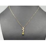 9ct gold multi stone set pendant and chain. Comprising of diamond, peridot, blue topaz and