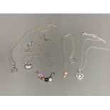 Four silver pendants on silver chains and two other silver pendants 27.6g gross