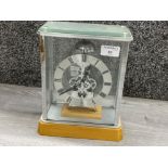 Skeleton mantle clock in glass display case