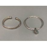 A silver torque style bracelet and another 33.8g