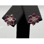 Ladies 9ct gold red and pink stone diamond stud earrings. All stones set in white gold.