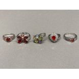 Five silver rings, one butterfly pattern with red stones 23.1g gross