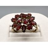 Ladies 9ct gold Garnet cluster ring. Comprising of 10 marquee cuts and 3 round cuts. 3.7g size R