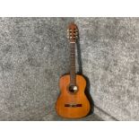 An acoustic guitar by Palma, model number C 103N