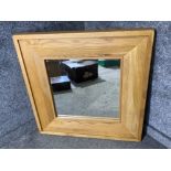 A large heavy oak framed bevelled mirror 90 x 90cm