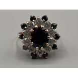 Ladies 9ct gold sapphire and cz cluster ring. 1.25ct central stone 3.3G size K
