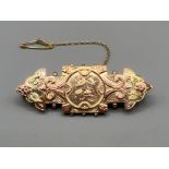 Ladies antique hallmarked 9ct gold and rose gold ornate design brooch with leaf and flower design.