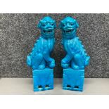 A pair of Chinese blue glazed Foo dogs 31cm high