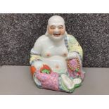 A ceramic laughing Buddha 25cm high