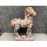 A Chinese pottery war horse, signed to base 35cm high