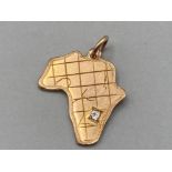 9ct gold map of Africa pendant set with a diamond 2.2g gross