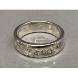 A Tiffany & Co style silver band size O 4g