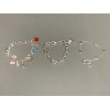 Three silver charm bracelets , one with enamel charms and another with CZ dragonfly charm 45.3g