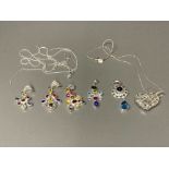 Silver jewellery with multicoloured stones, a heart shaped silver pendant and three silver chains