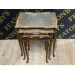 Carved oak nest of three tables with glass tops