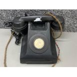 A vintage heavy Bakelite black telephone