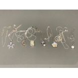 Seven silver pendants on silver chain, and another silver chains 55.1g gross