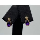 Ladies 9ct Yellow Gold Amethyste and diamond studs, set with a oval Amethyste and a round