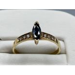 Ladies 9ct Yellow Gold sapphire and diamond ring, comprising of a marque shaped sapphire with 3