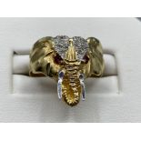 9ct yellow gold stone set elephant ring, featuring 2 red rubys in the eyes with white stones in