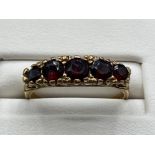 Ladies 9ct Yellow Gold garnet ring featuring 5 round shaped garnets set across the band, 2.6grm size