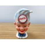 A cast metal Coca Cola (head) money bank