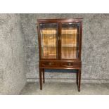 A reproduction mahogany display unit with bevelled glass doors 91 x 160 x 36cm