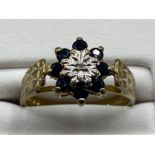 Ladies 9ct Yellow Gold sapphire and diamond cluster ring, comprising of a single diamond set in