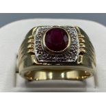 Gents 9ct Yellow Ruby and diamond ornate ring, featuring a oval shaped ruby in the centre surrounded