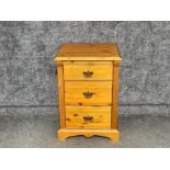 A pine bedside chest of drawers