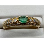 Ladies 18ct Yellow Gold emerald and diamond ring, featuring a oval shaped emerald set in the centre,