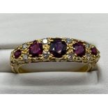 Ladies 18ct Yellow Gold ruby and diamond 5 stone ring, comprising of 5 round red stones with 8 round
