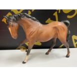 Beswick brown horse (foot raised) figurine in a matte finish