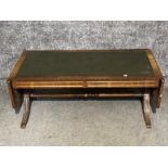 A reproduction inlaid mahogany and leather inset topped drop leaf coffee table 152 x 53 x 43cm