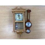 An oak cased wall clock by Daniel Dakota, and a reproduction mahogany framed barometer by