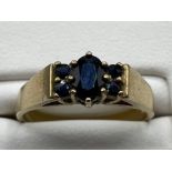 Ladies 9ct Yellow Gold black sapphire ring, featuring a oval stone in the centre with 2 smaller