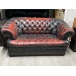Dark Red leather & metal studded chesterfield two seater sofa