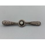 Ladies silver ornate stone set wedgewood brooch, featuring a round black stone in the centre with