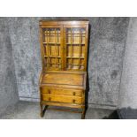 Oak bureau bookcase with double glazed door top & barley twist supports, with key