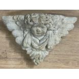 Concrete cherub wall pocket