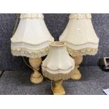 Pair of marble based table lamps with cream fringed shades, plus one other