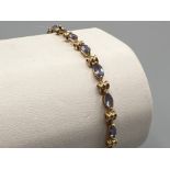 Ladies 9ct gold light purple stone set bracelet. 4.3G