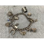 Silver curb link charm bracelet with 11 charms (46.8g)