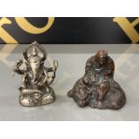 An antique bronze Chinese scroll weight cast in the form of Guanyin seated on the back of a