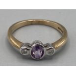 Ladies 9ct yellow gold light purple stone and diamond three stone ring size O 2.3g gross