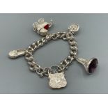 Ladies silver charm bracelet with slipper, pram, heart and fob charms 85.5g gross