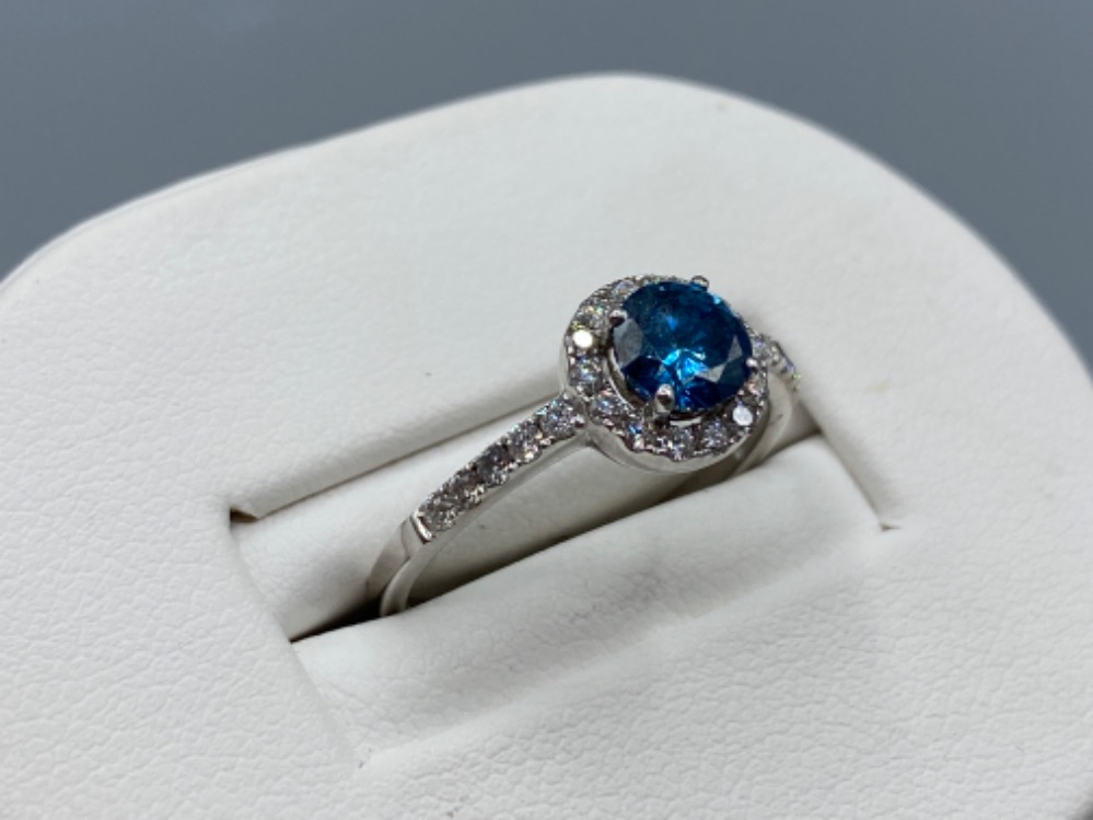 18ct white gold ring comprising of a 0.60ct blue diamond surrounded by a total of 0.30cts of - Image 2 of 3