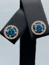 18ct White Gold Earrings comprising of a 1.40ct fancy coloured diamond center stone with 0.22ct
