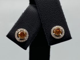 18ct White Gold Earrings comprising of a 0.60ct fancy coloured diamond center stone with 0.18ct