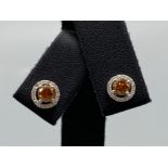 18ct White Gold Earrings comprising of a 0.60ct fancy coloured diamond center stone with 0.18ct